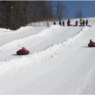 a man riding a snowboard down a snow covered slope