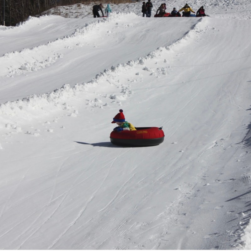 a man riding skis down a snow covered slope