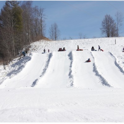a group of people riding skis down a snow covered slope