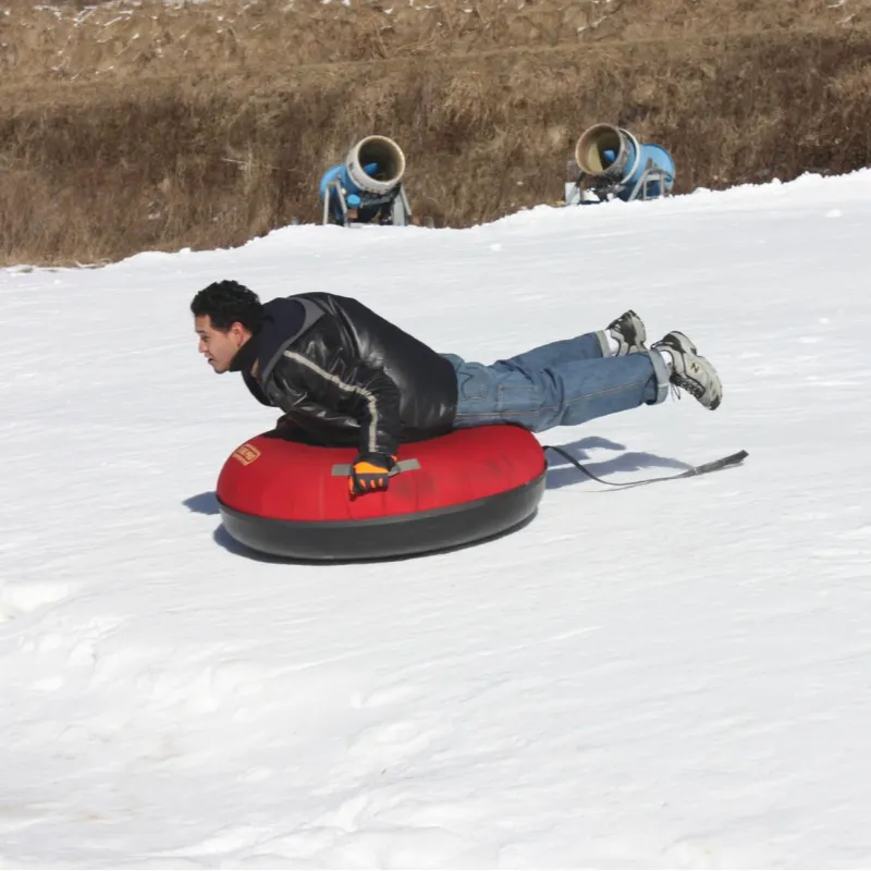 a person riding a snowboard down a snow covered slope
