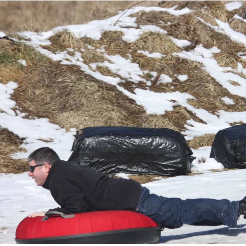 a man sitting on top of a snow covered slope