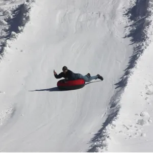 a man riding skis down a snow covered slope