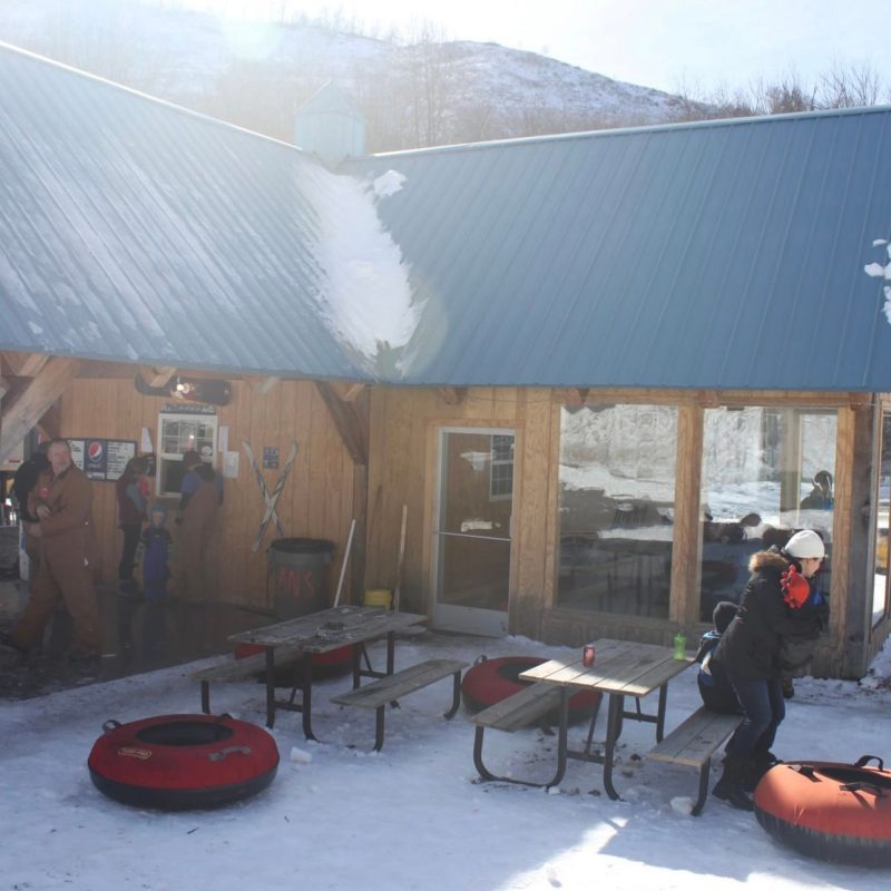a group of people sitting in chairs in front of a building