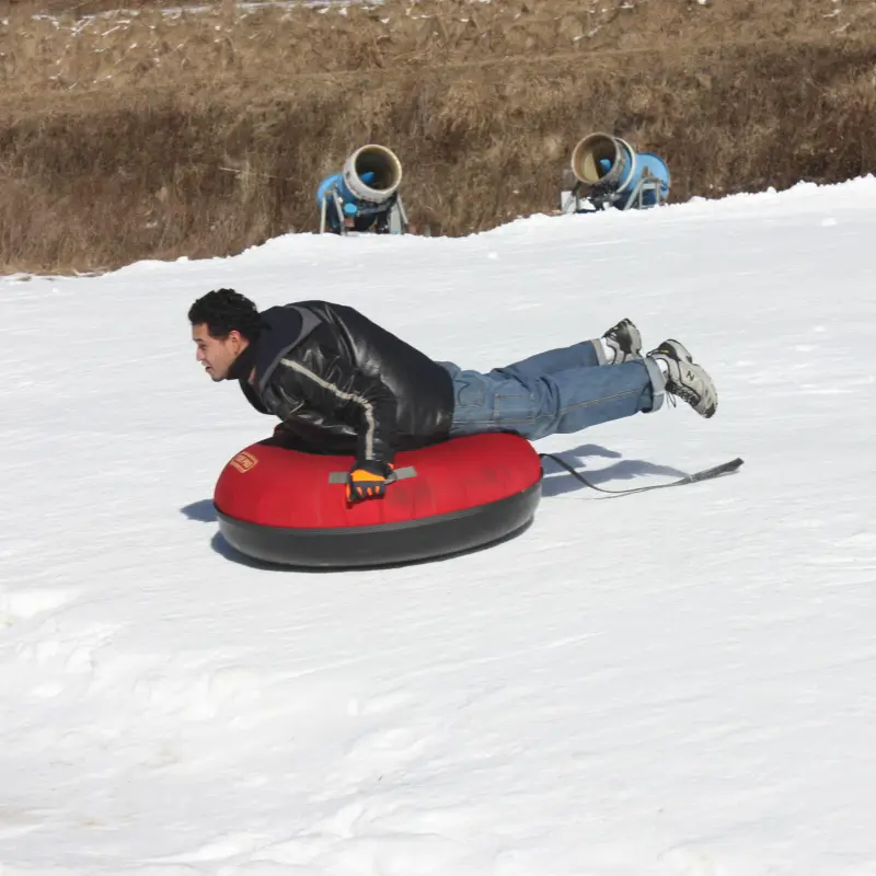 a person riding a snowboard down a snow covered slope